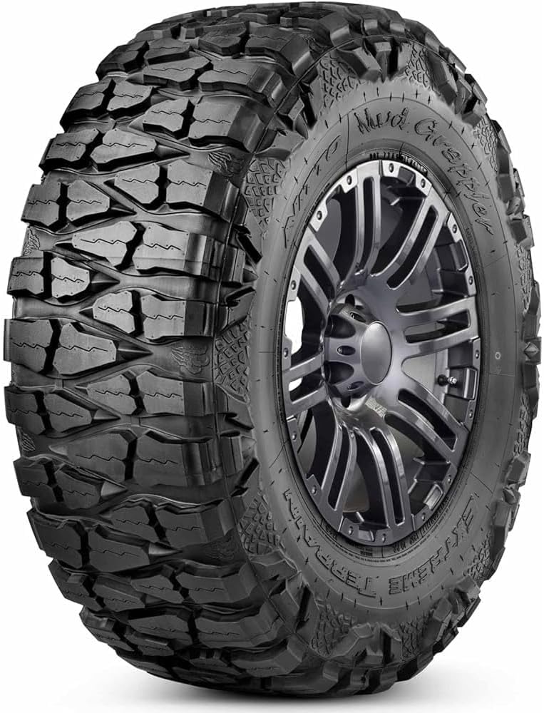 Nitto Mud Grappler extreme terrain tire on a dark alloy wheel, deep tread blocks wrapping onto the sidewall